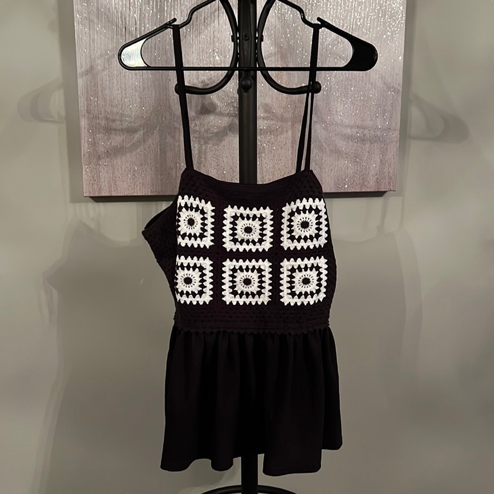 Crocheted, black-and-white, tank top with adjustable straps.